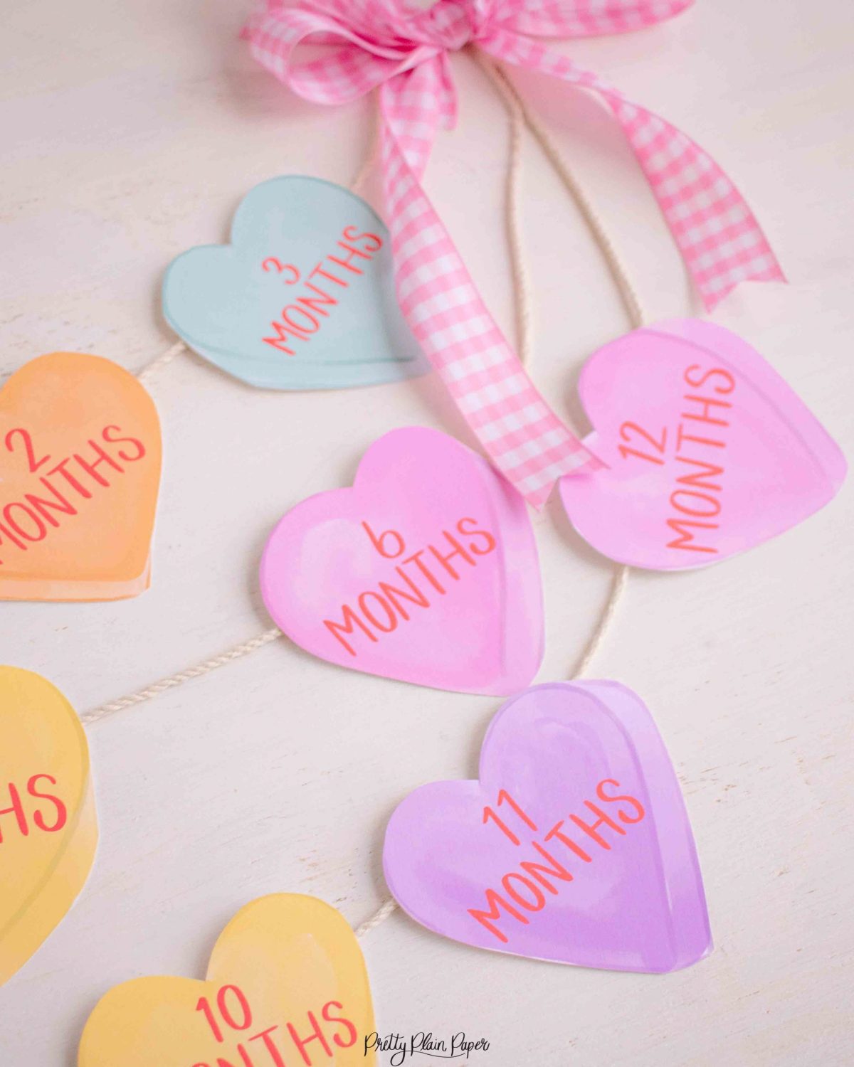 Candy Conversation Heart Pattern First Birthday Milestone Photo Banner Printable Download with Watercolor Hearts by Pretty Plain Paper, Valentine Theme Birthday Party Decor