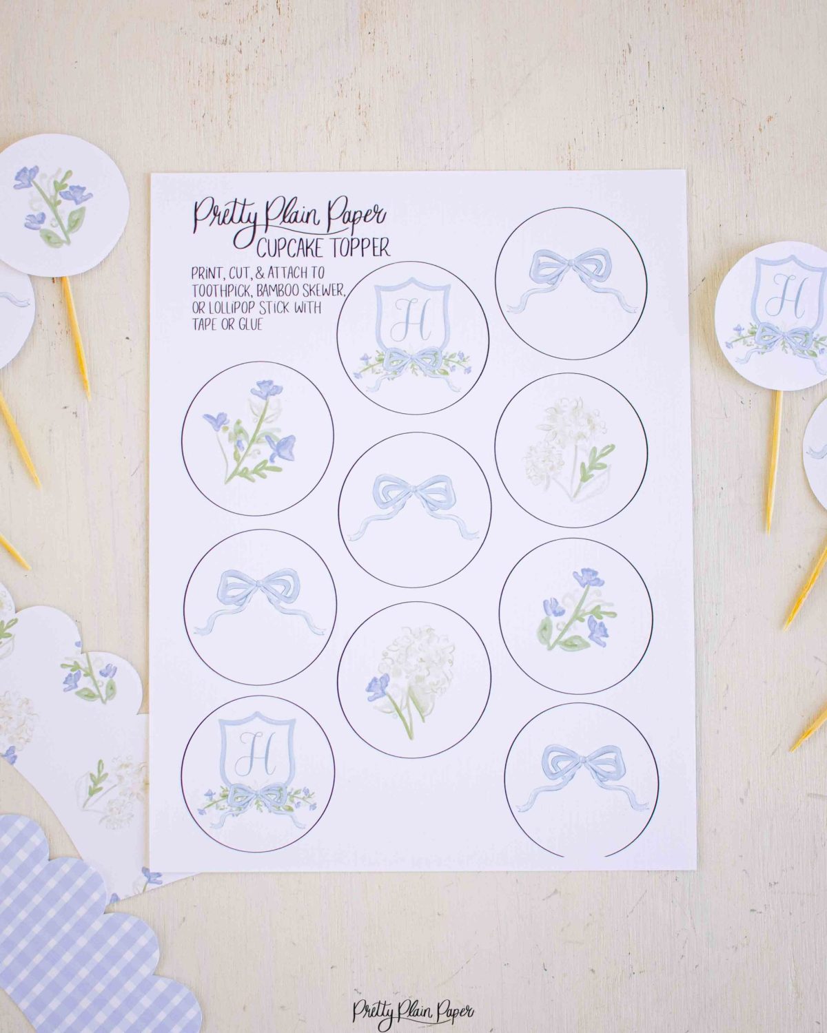 Monogram Crest, Blue Floral and Blue Bow Cupcake Wrapper Printable by Pretty Plain Paper
