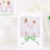 Watercolor Christmas Card with Photo by Pretty Plain Paper a Grandmillennial Christmas Card with Green Bow and Monogram Wreath Crest with Greenery